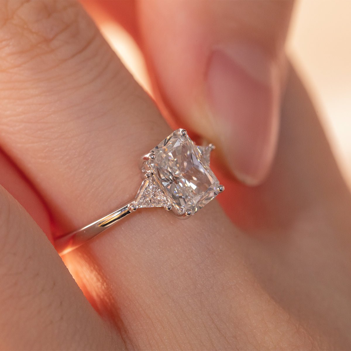 14K White Gold 1.5ct Radiant Cut Lab Diamond Three Stone Ring with Triangular Cut Lab Diamond Side Stones and Tapered Band Design - MMR