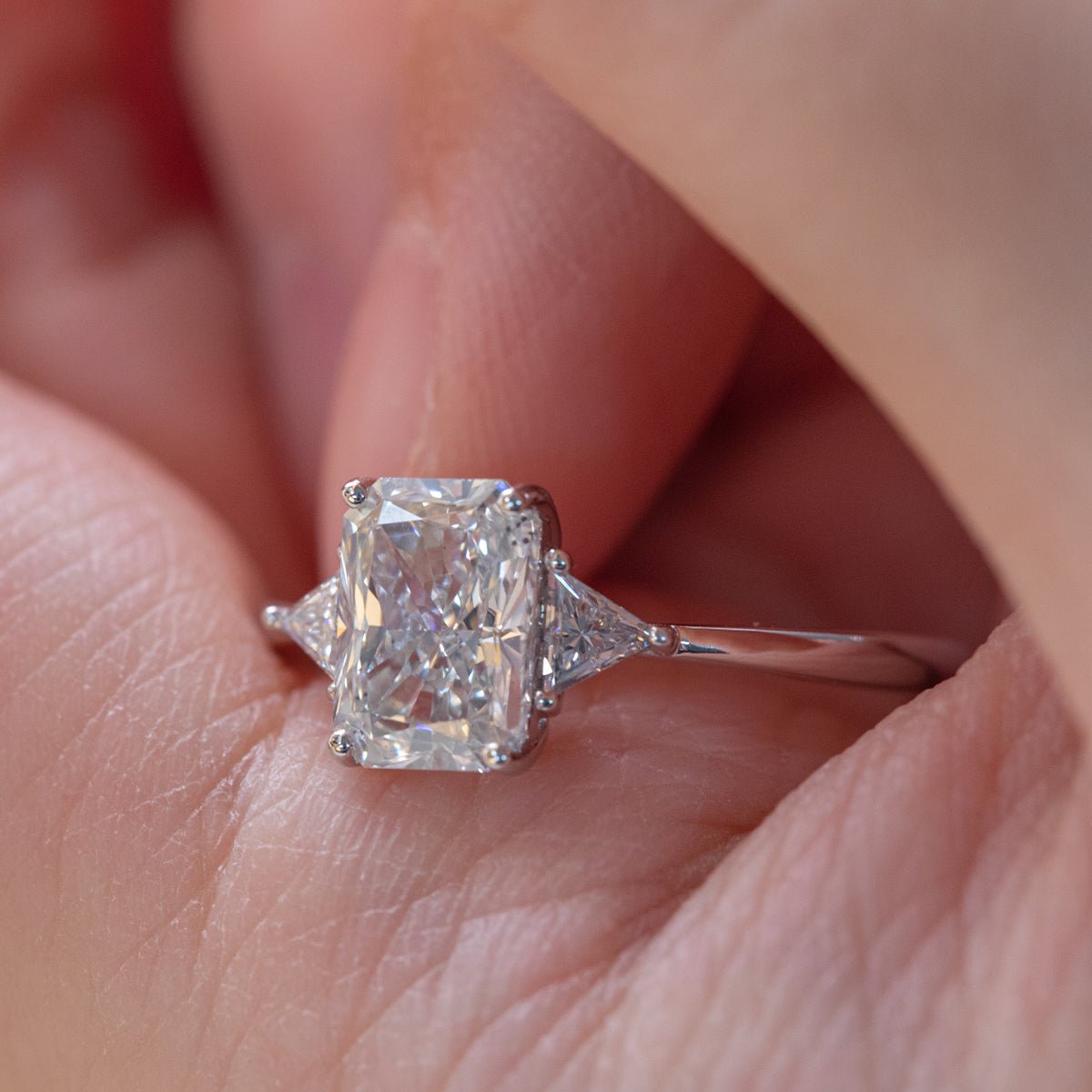 14K White Gold 1.5ct Radiant Cut Lab Diamond Three Stone Ring with Triangular Cut Lab Diamond Side Stones and Tapered Band Design - MMR